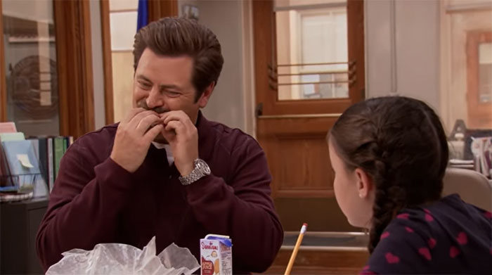 Ron Swanson eating a sandwich