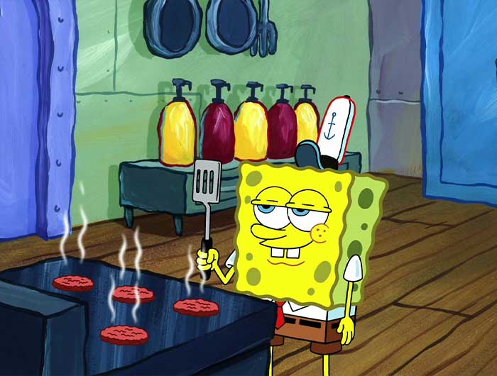 Spongebob frying patties while looking proud