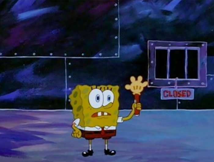 Spongebob holding up a hand looking torch in a very dark room