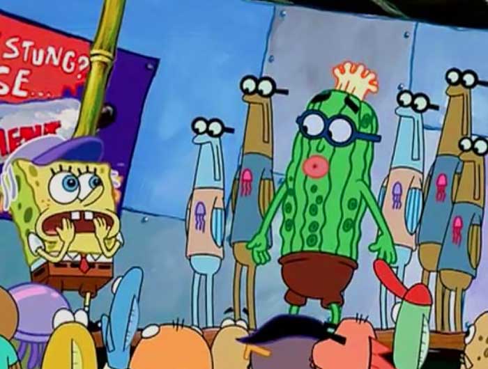 Spongebob looking up at Kevin the cucumber with an astonished look