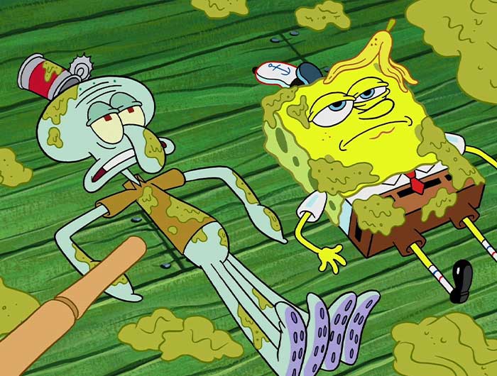 Squidward and spongebob laying on the ground covered in dirt