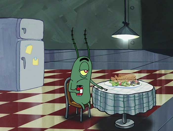 Sheldon J. Plankton looking depressed in a kitchen next to a holographic sandwich