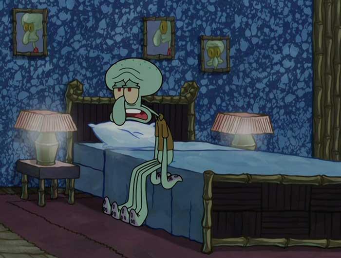 Squidward looking depressed, sitting on his bed