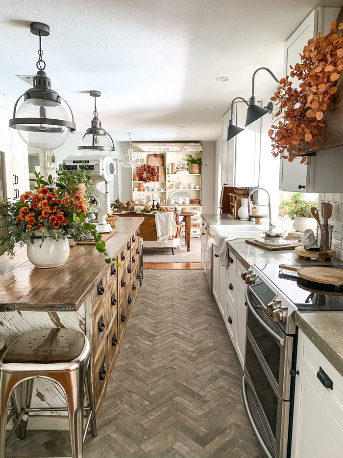 cozy kitchen with wooden kitchen island and autumn inspired decorations
