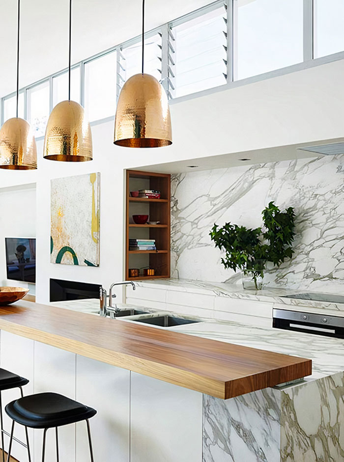 a kitchen with a mixed marble and wood kitchen island