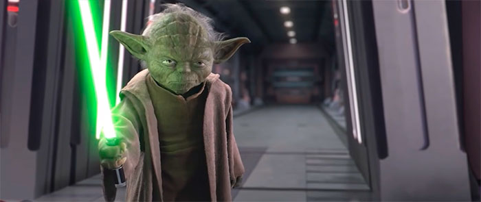 Yoda holding a lightsaber chopstick