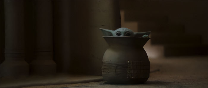 Baby Yoda sitting in a pot