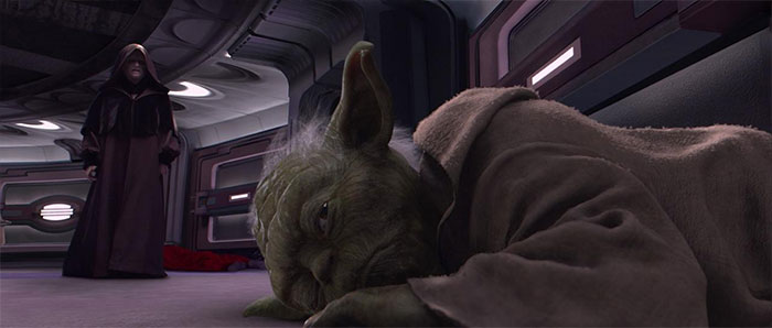 Yoda lying down on the ground with eyes open