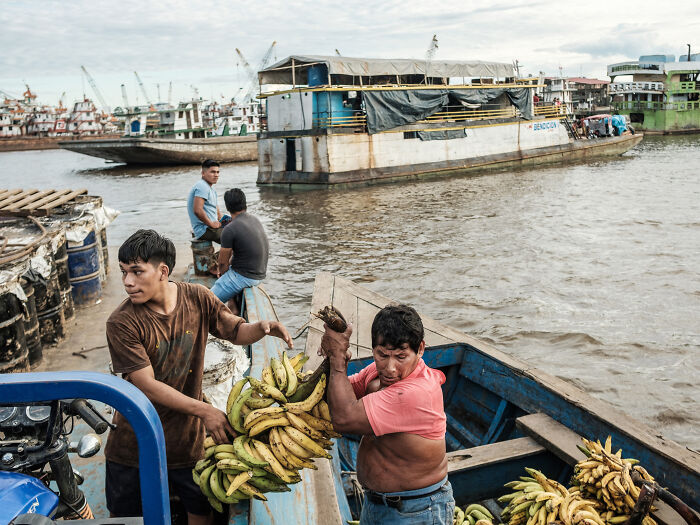 Bananas are being offloaded on a smaller boat as we approach the port of Iquitos