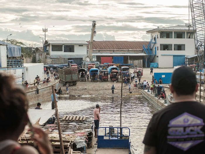 Moto taxis and trucks wait to pick up the passengers and cargo as our boat arrives at the port of Iquitos