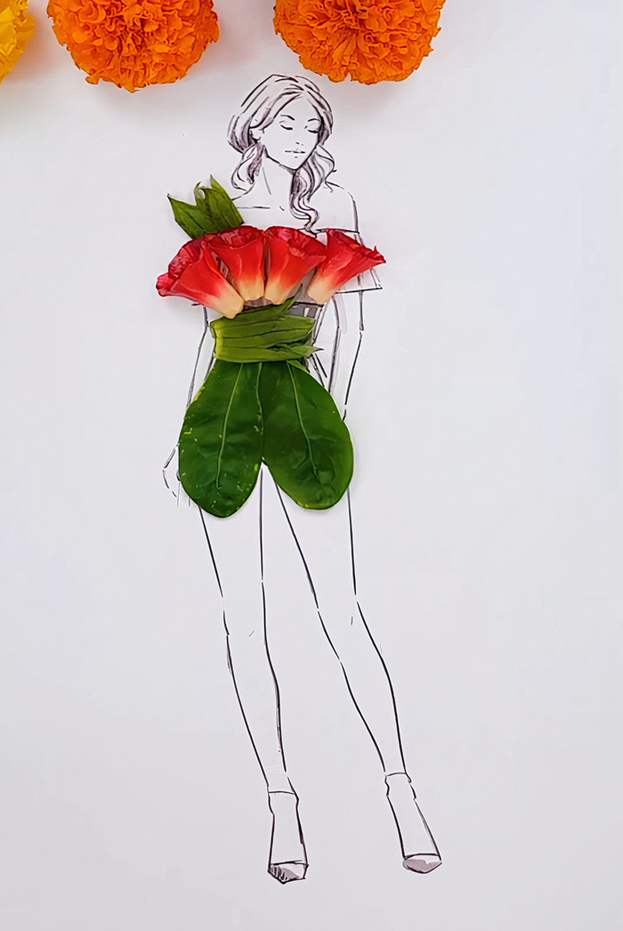A drawing of a woman dressed in real flower petal and leaf gown