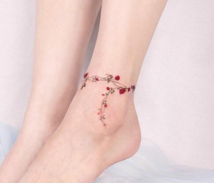 Fine line flowers tattoo on ankle