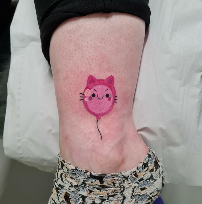 Pink cat ballon ankle tattoo