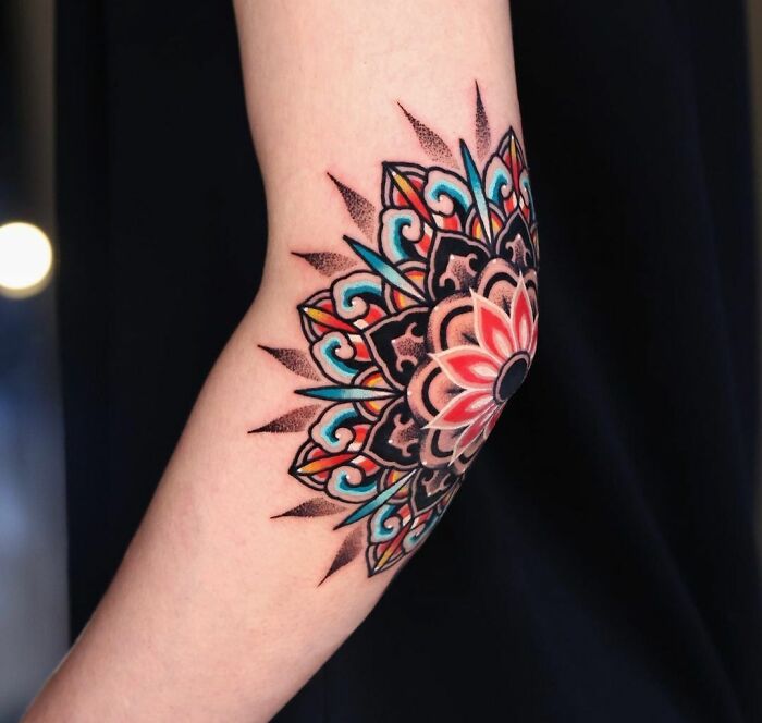 Colorful mandala tattoo on the elbow