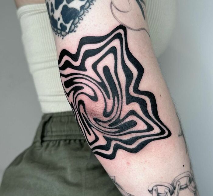 Trippy elbow tattoo