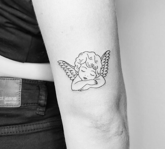 Cute Cupid tattoo on the elbow