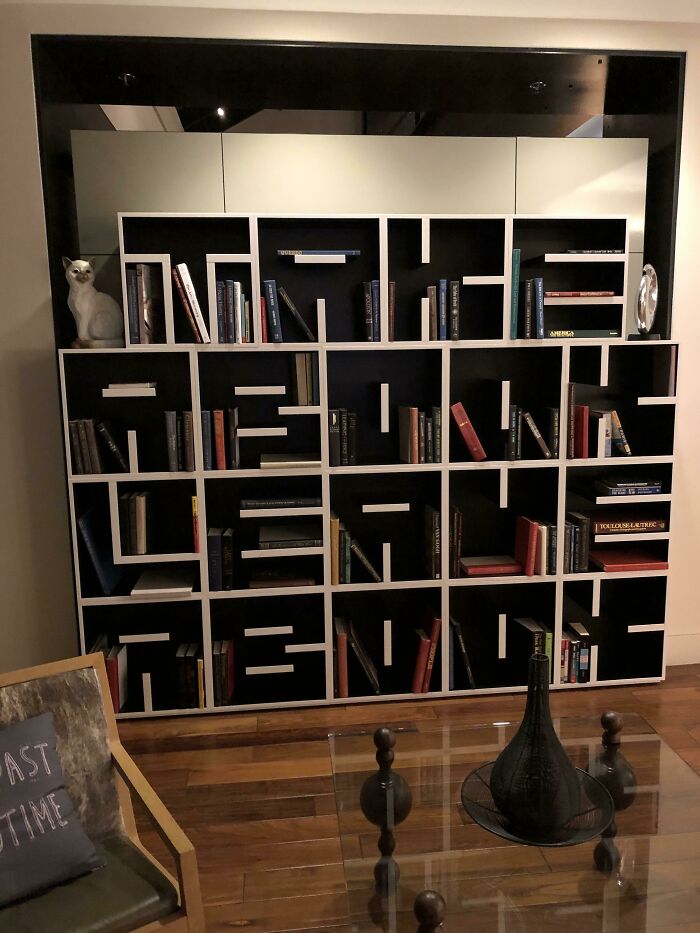 A Really Cool Bookshelf Whose Shelves Spell Something, Seen At A Hotel
