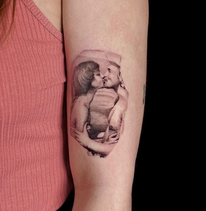 Picture of parents kissing arm tattoo
