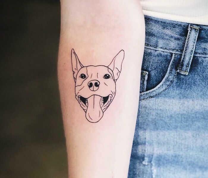 Graphic dog face memorial forearm tattoo