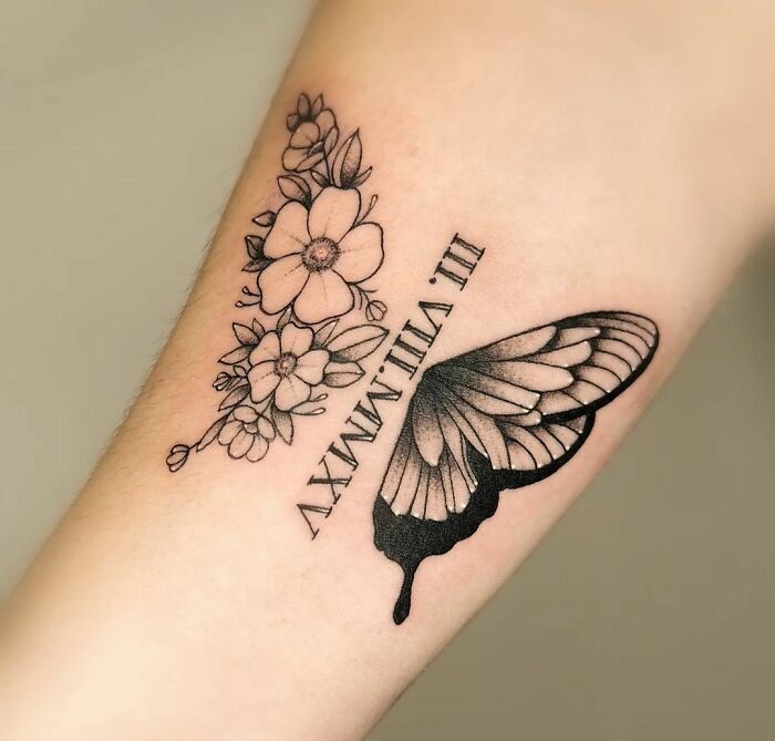 Memorial tattoo with Roman numerals date, flowers and butterfly 