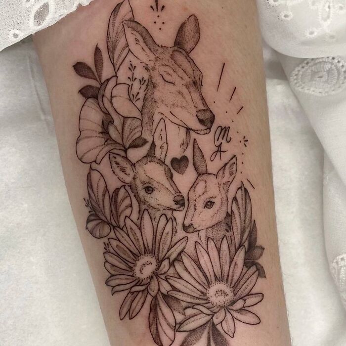 Deer family with flowers arm tattoo