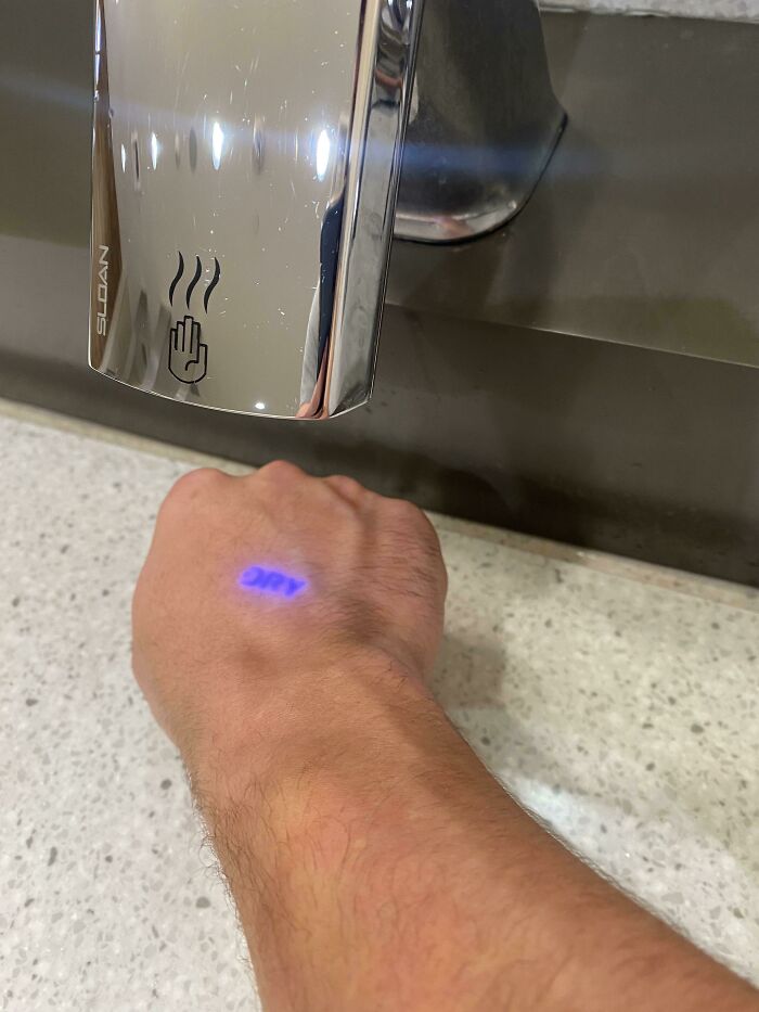 Hand Dryer Projects The Word Dry While Using It