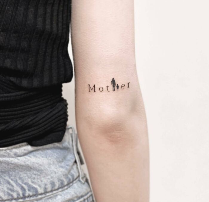 Mother letters arm tattoo