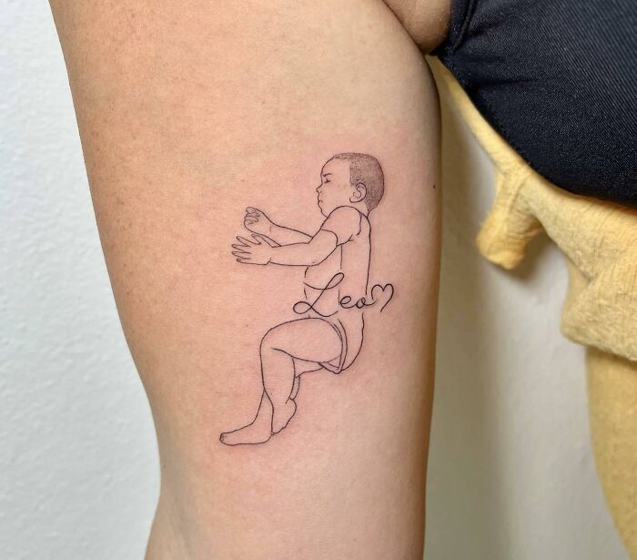 Baby and name arm tattoo