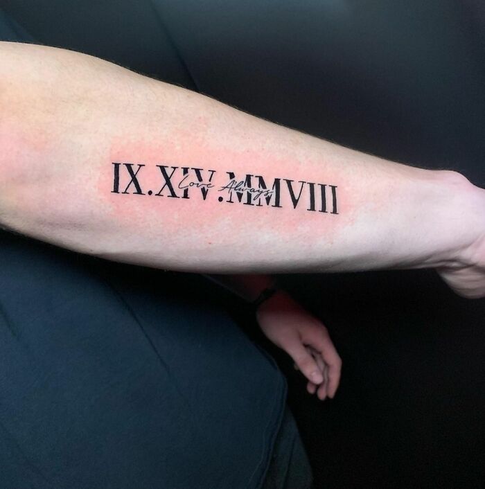 roman numerals on arm memorial tattoo