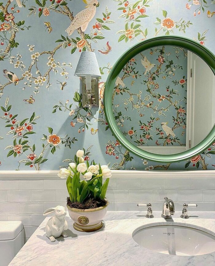 Bathroom with marble sink and blue wallpaper featuring branches and birds, showcasing trendy bathroom wallpaper ideas. Bathroom with marble sink and blue wallpaper featuring branches and birds, showcasing trendy bathroom wallpaper ideas.