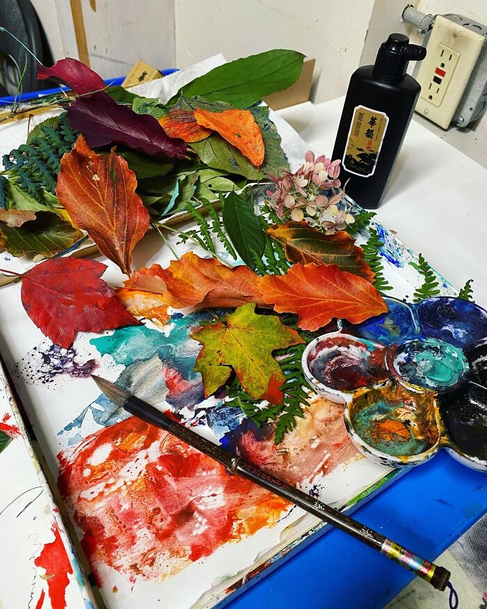 Artist Table With Ink And Autumn Leave