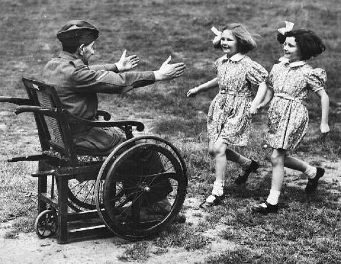Two Girls Greet Their Wounded Father Returning Home From War. 1940