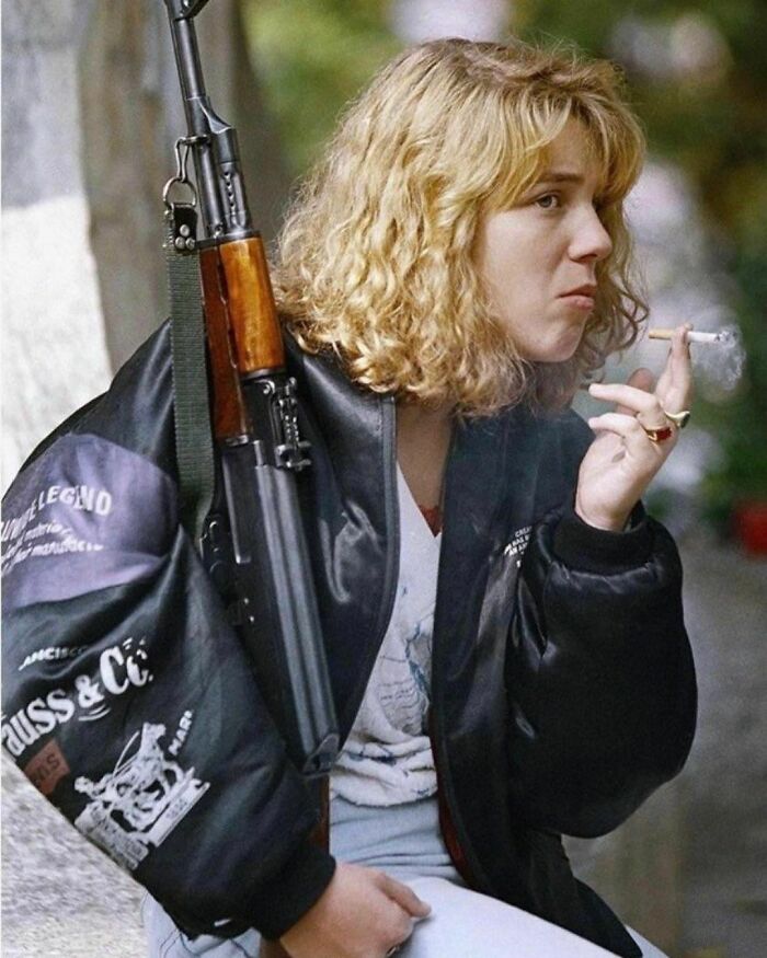 Bosnian Girl With An Ak-47, Smoking Smokes While Waiting For A Funeral Service At Sarajevo’s Lion’s Cemetery On Monday, Sept. 14, 1992