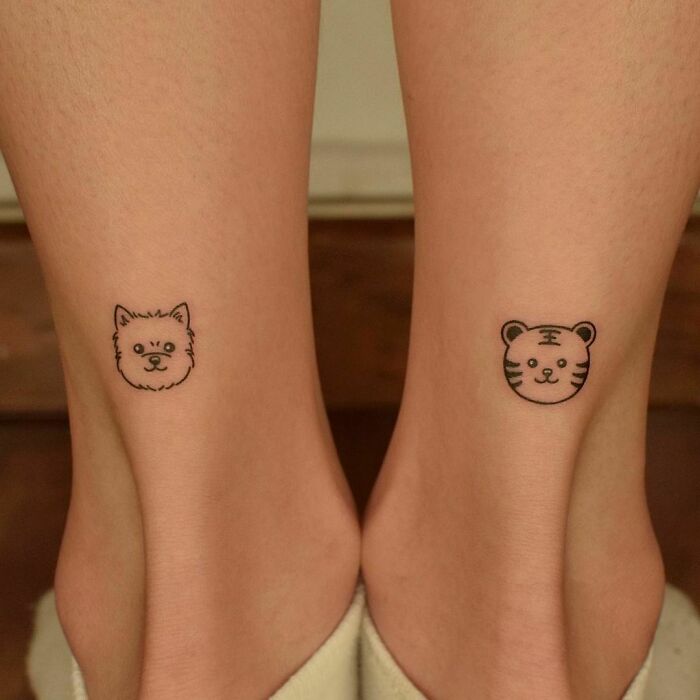 Minimalistic puppy and tiger heads ankle tattoo