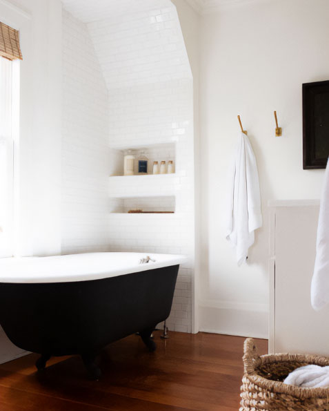 Acrylic clawfoot tub for a black and white bathroom.