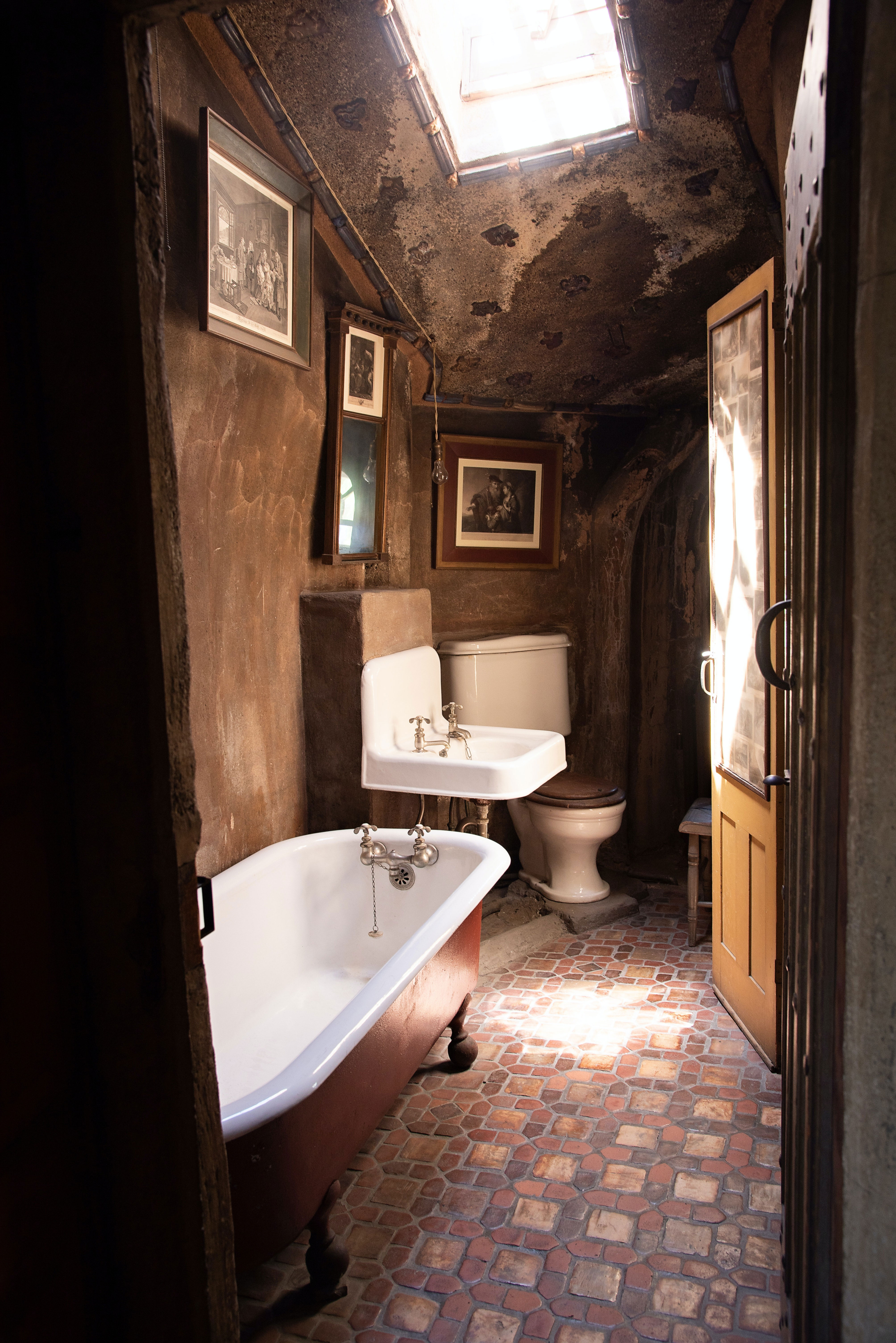 Clawfoot tub in a rustic bathroom.