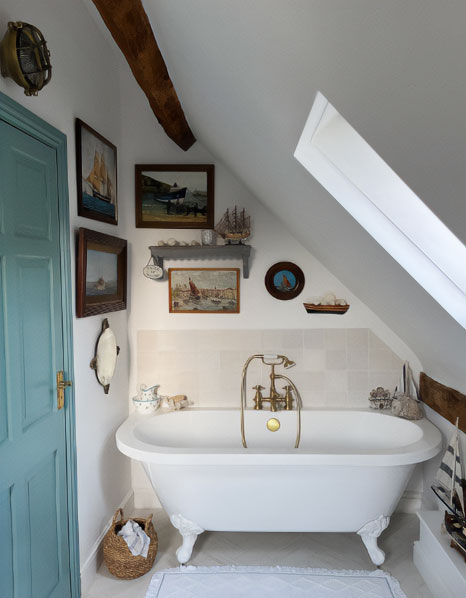 Clawfoot tub with classy finishes in a vintage style bathroom.
