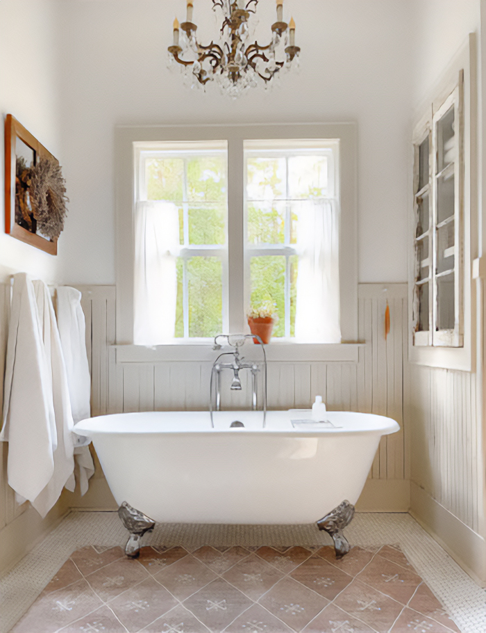 White double ended clawfoot tub near window.
