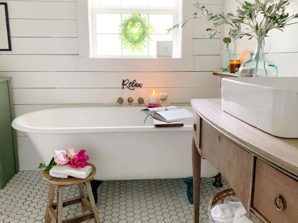 Classic clawfoot tub for whitewashed bathroom.