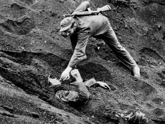 March 16, 1945: A U.S. Marine Approaches A Japanese Soldier On Iwo Jima, Japan During World War II