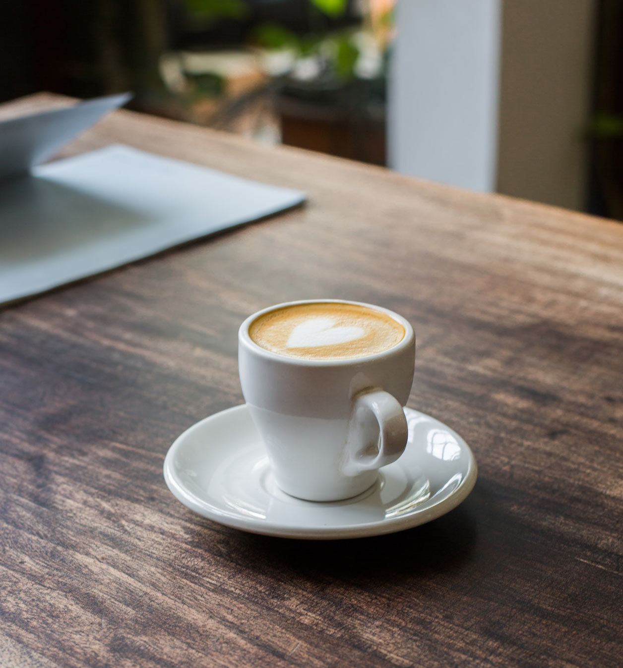 A cup of coffee on a wooden table A cup of coffee on a wooden table
