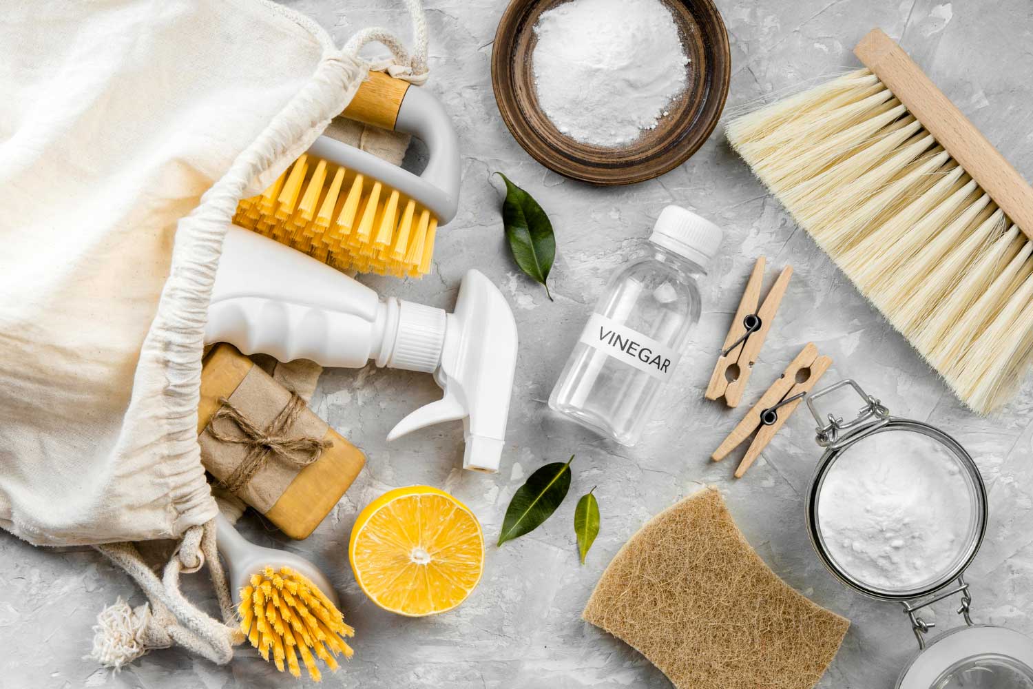 Flat lay of eco-friendly cleaning products with brushes and lemon