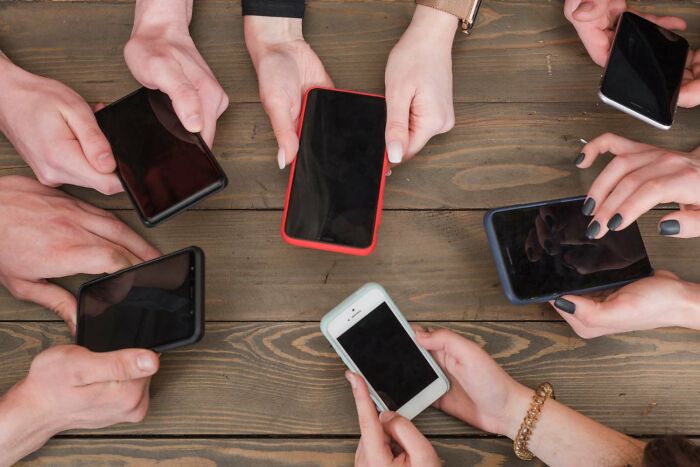 Group of people using smartphones