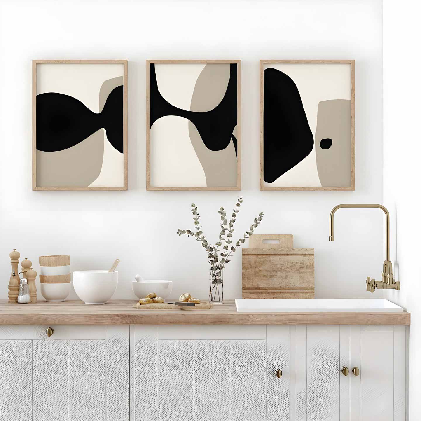 Three framed minimal artworks hanging inside kitchen