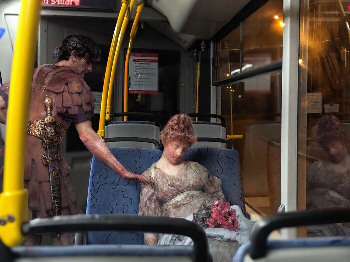 An image of a man and a woman from "A Silent Greeting" painting in a bus