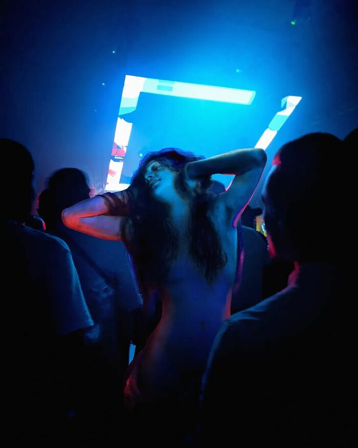 An image of a woman from "Voluptas" painting in a disco