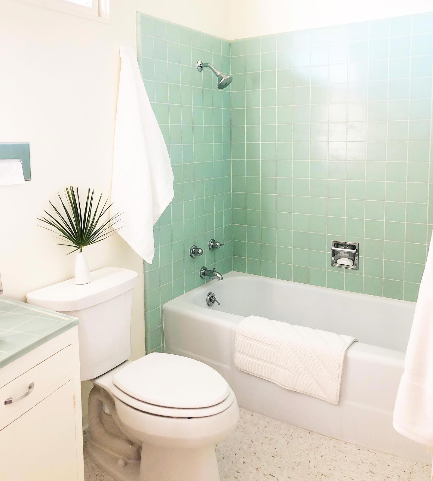 Minty green tiles in the white bathroom
