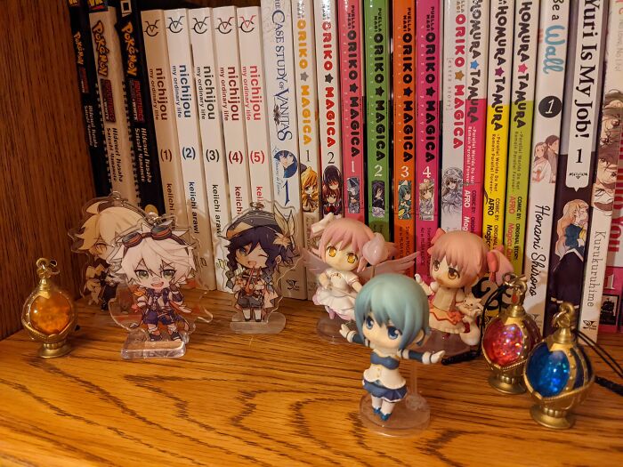 My Manga Shelf With Some Nendoroid Petits, Acrylic Charms, And Phone Charms