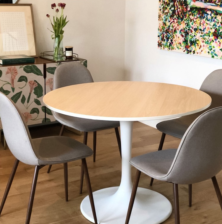 Round IKEA kitchen table with four gray chairs