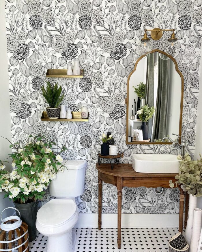 Bathroom with black and white bold floral wallpaper featuring a wooden sink table and white toilet for trendy bathroom wallpaper ideas. Bathroom with black and white bold floral wallpaper featuring a wooden sink table and white toilet for trendy bathroom wallpaper ideas.